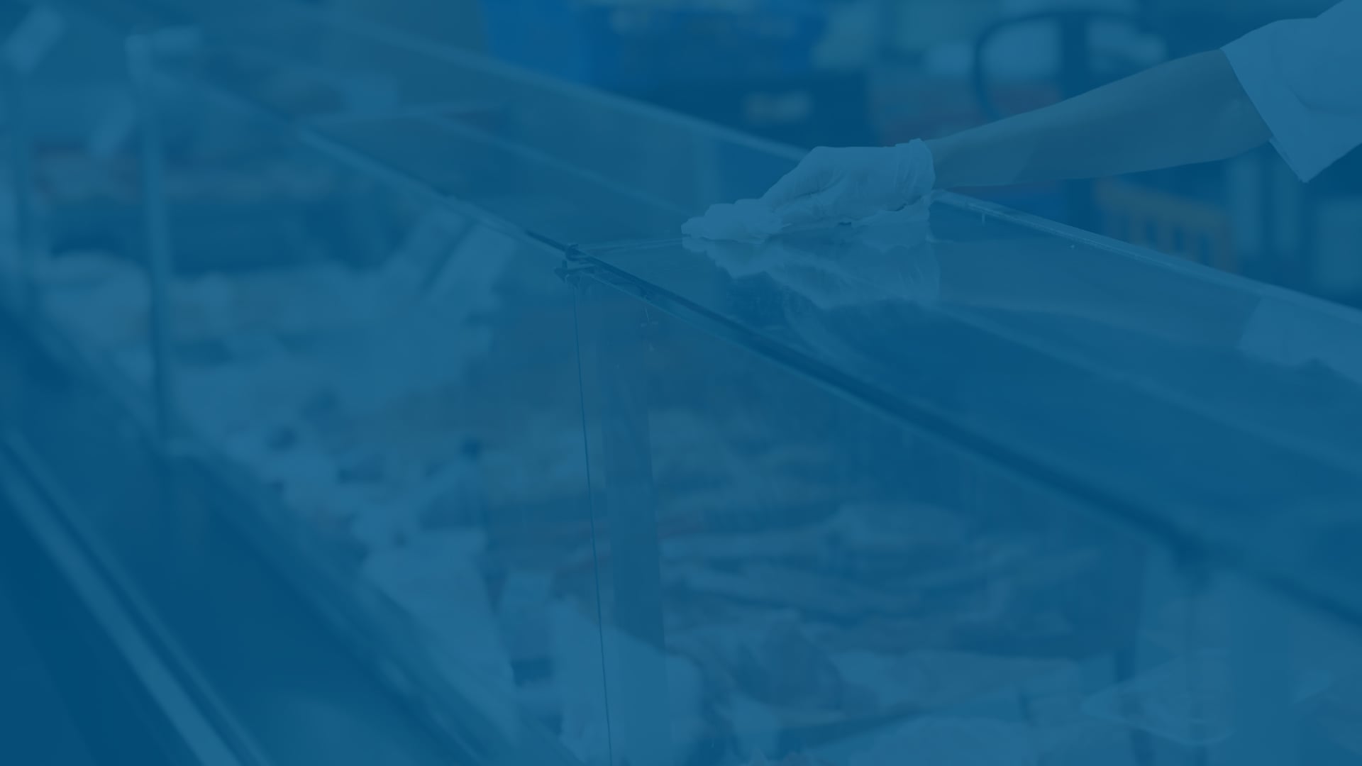 food retail display case being wiped down